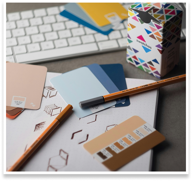 blue swatches, pencils and keyboard on a desk